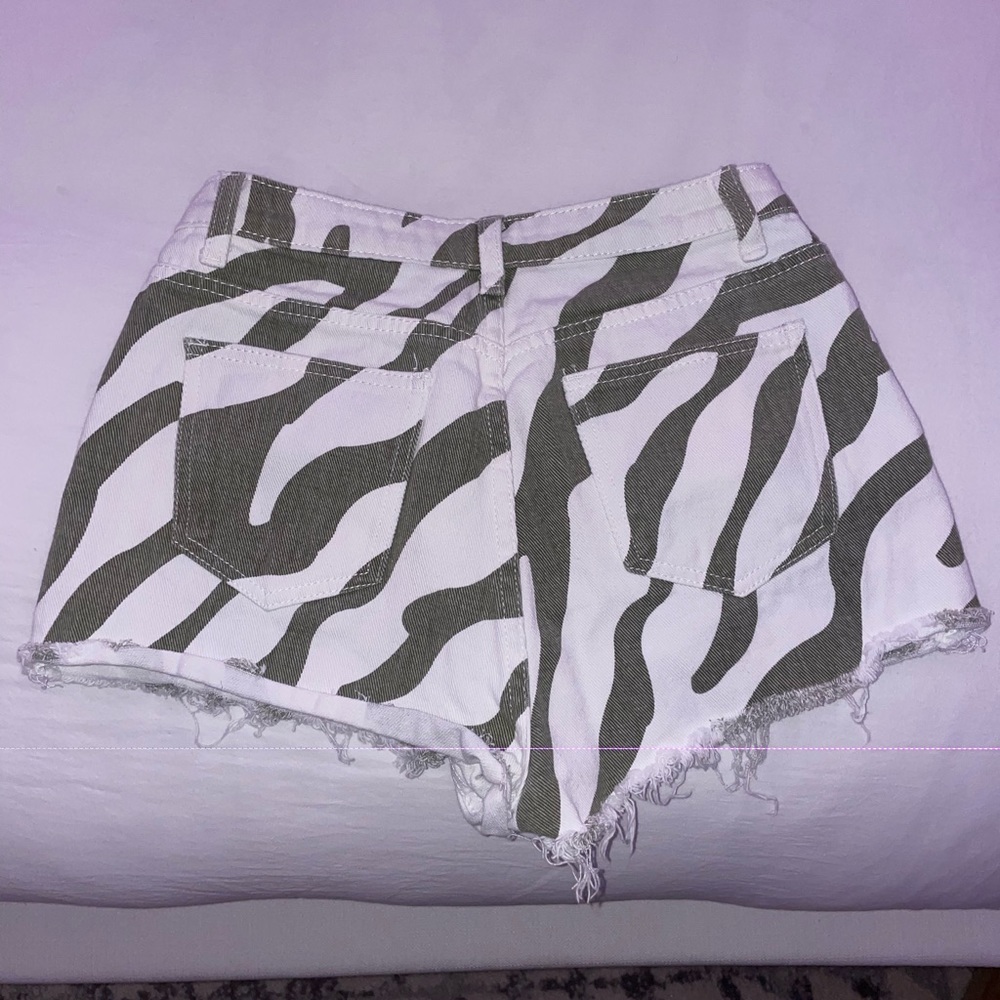 green and white patterned jean shorts